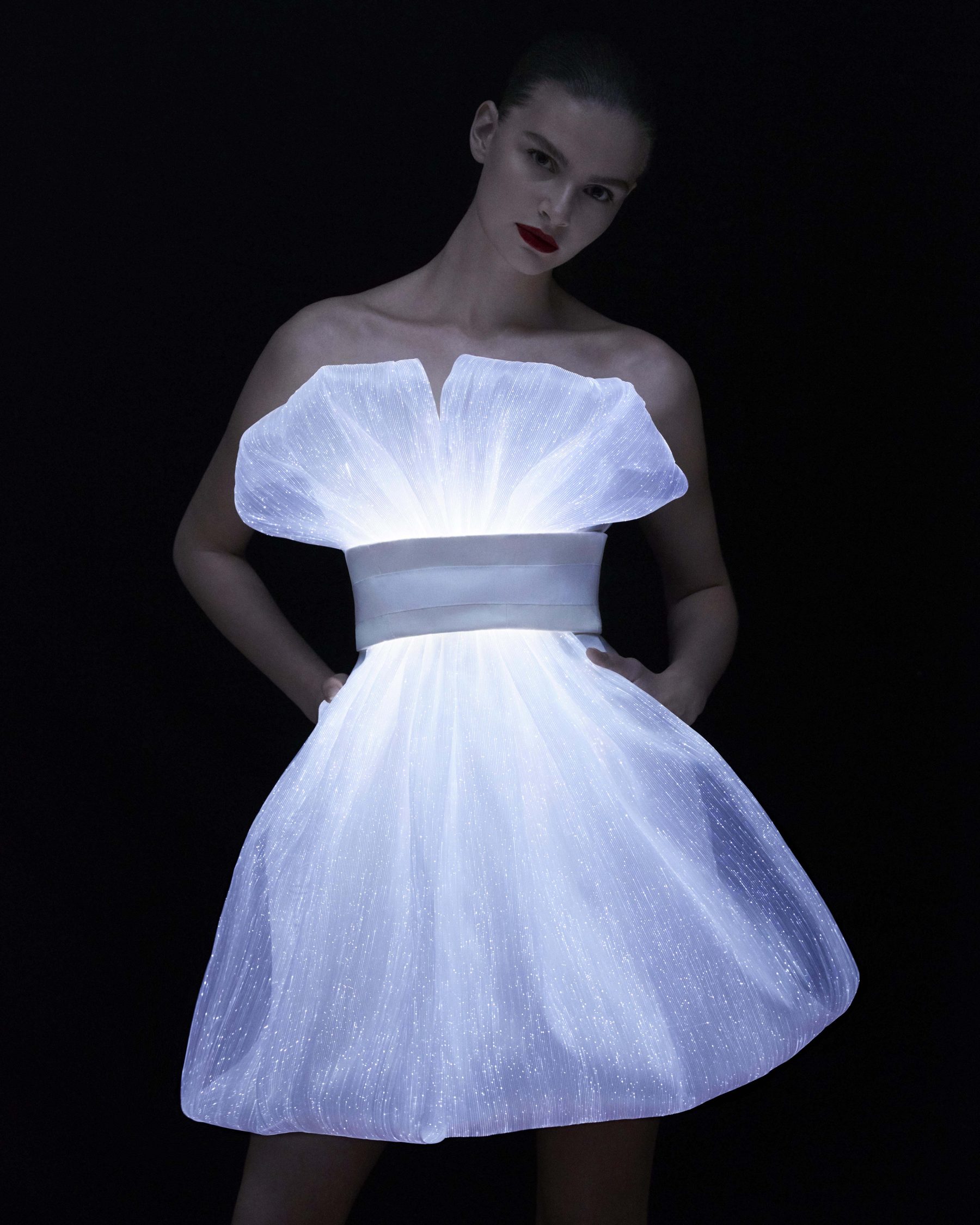 Illuminated cocktail dress woven from fiber-optic organza